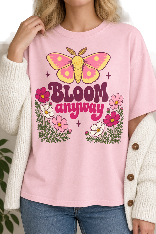 Woman wearing the Bloom Anyway moth tee in light pink