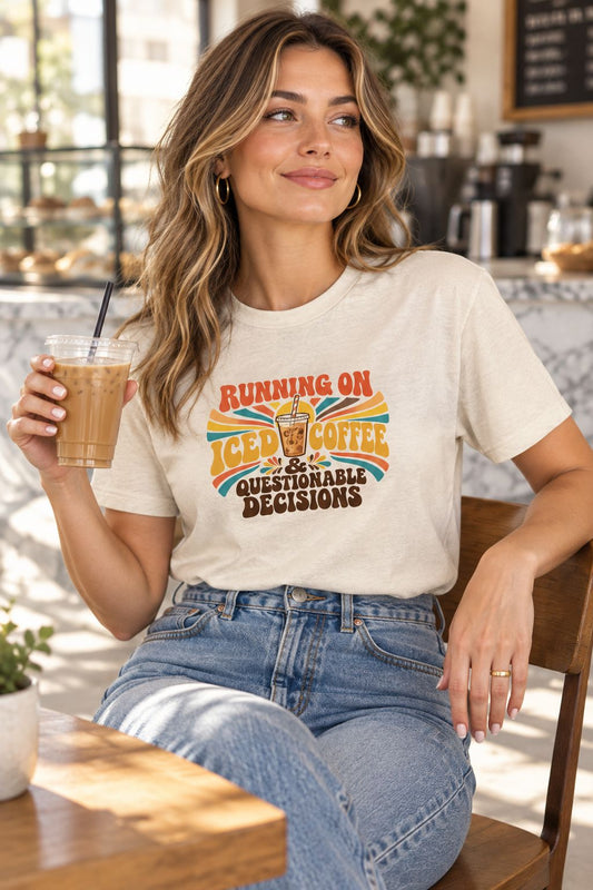 Woman wearing the Running on Iced Coffee & Questionable Decisions retro tee in a coffee shop